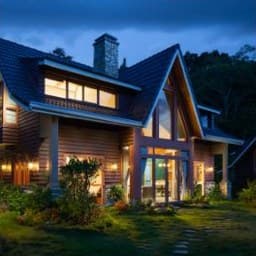 After: well-kept house with lights on at dusk
